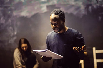 Image of an actor in rehearsal with script in hand.