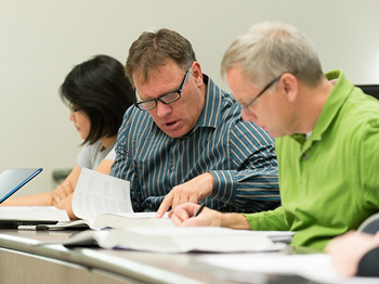 Image of a Business Manager conferring with a Board member.
