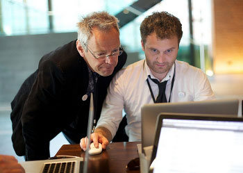 Image of a Chief Executive Officer working with a staff member