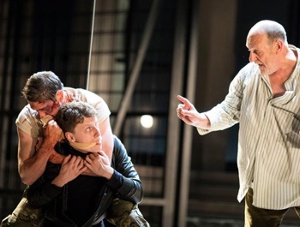 Photo of a Fight Director working with two actors.