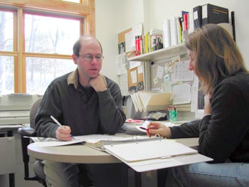 Photo of a Production Manager working with another staff member.