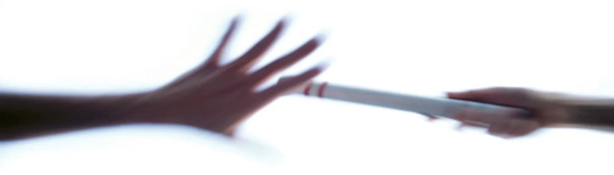 two hands passing a baton